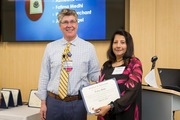Fatima Mehdi receives a certificate for five years of service recognition.