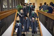 Graduates proceed to the reception following the ceremony.