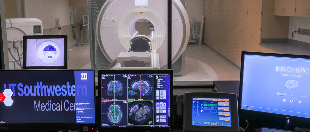 Room of computers looking into a room with an MRI machine