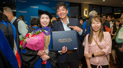 Jiwon Song, Ph.D., is supported by her family post-commencement.