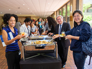 Members of the UTSW community, along with Vice President for Community and Corporate Relations Ruben E. Esquivel (second from right) sample the reception fare.