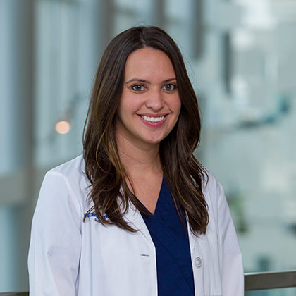 Woman in white lab coat