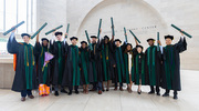 UT Southwestern Medical School graduates raise their diplomas in celebration of earning their medical degrees. More than 200 students celebrated commencement on May 11 at the Morton H. Meyerson Symphony Center.