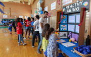 A couple of young students check out healthy aging tips – and make brains out of Play-Doh.