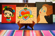 The reception included a display of Hispanic-Latino artwork that included (from left) a Lele Doll, La Corazon Milagro, and La Catrina.