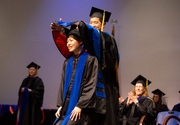 Dr. Yu-San Yang is hooded by Dr. Benjamin Tu at the Commencement ceremony of the Graduate School of Biomedical Sciences.