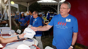 John Warner, M.D., UTSW Executive Vice President for Health System Affairs and Health System CEO, helps out at the Heart Walk along with UTSW President Daniel K. Podolsky, M.D. (left).