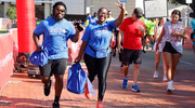 Two walkers joyfully cross the finish line.