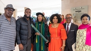 Olaide Sode, M.D., M.P.H., and her family gather for a celebratory photo.