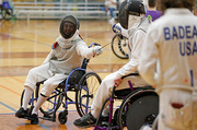 A player makes a move in a fencing match.