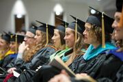 Watching the ceremonies are School of Health Professions faculty members.