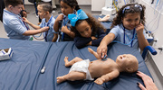 Second graders from Biomedical Preparatory at UT Southwestern take turns using stethoscopes in October on a field trip to the UTSW Simulation Center to learn more about medical technology. The Sim Center provides hands-on training to health care learners, enabling them to become skilled clinicians.