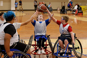 Players prepare for tip-off in wheelchair basketball.