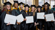 Physician Assistant (PA) Studies program graduates proudly display their diplomas in a group photo with PA faculty member Bethany Grubb, M.P.A.S.
