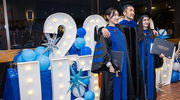 Neuroscience graduates Xinke Wen, Ph.D., left, and Gulhumay Gardashova, Ph.D., right, celebrate with Daisuke Hattori, Ph.D., Assistant Professor of Physiology and Neuroscience.