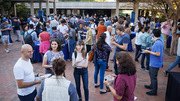 Attendees enjoy the outdoor reception at the Brown and Goldstein event.