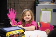 This young student is all smiles while working on her craft project.