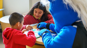 Champ, the mascot of the Dallas Mavericks, shares crayons with children at the UT Southwestern Pediatric Group at Plano. Champ visited the clinic in April on Cape Day, the local spin on National Superhero Day, to show support for pediatric care teams and patients. The event is a collaboration of the team, UTSW, and Children’s Health.