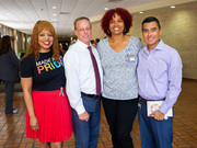 Employees show off rainbow ribbons in support of Pride.