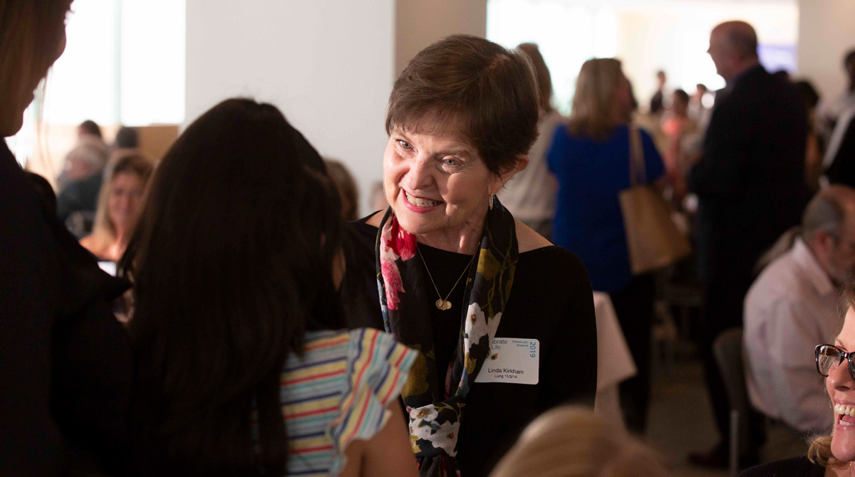 Recipients chatting around dining tables