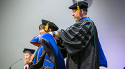 Rui Chen, Ph.D., is hooded by her mentor, James Collins, Ph.D., Associate Professor of Pharmacology.