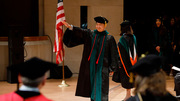 Dr. Anthony Han waves to family and friends upon receiving his degree.