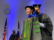 Dr. Rolf Brekken, Professor of Surgery, Pharmacology, and in the Hamon Center for Therapeutic Oncology Research, hoods Dr. Demetra Kelenis, who earned her doctorate in cancer biology. Dr. Kelenis is a Medical Scientist Training Program student.