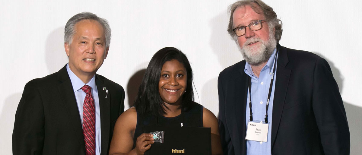 Brittany Johnson is congratulated at the Gilliam Fellowship pinning ceremony by Dr. David Asai (left) and Dr. Sean Carroll of HHMI.