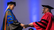 Tahnae Tarkenton Allen (left) receives her diploma from Dr. Podolsky.