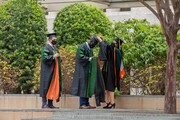 A graduate does one final tassel check before lineup.