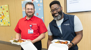 Thomas Arnold (left) and Derick Sillers, Technical Support Specialists in the Department of Internal Medicine, are ready to enjoy the food.