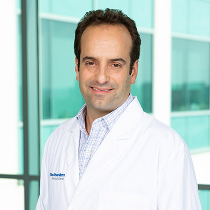 Man with buttoned shirt wearing lab coat