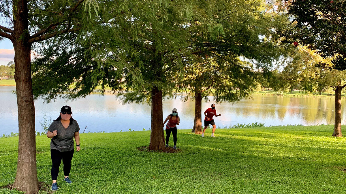 People outside walking near trees