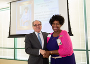 Dr. Daniel K. Podolsky shakes hands with 45-year service honoree Gwen Griffin.