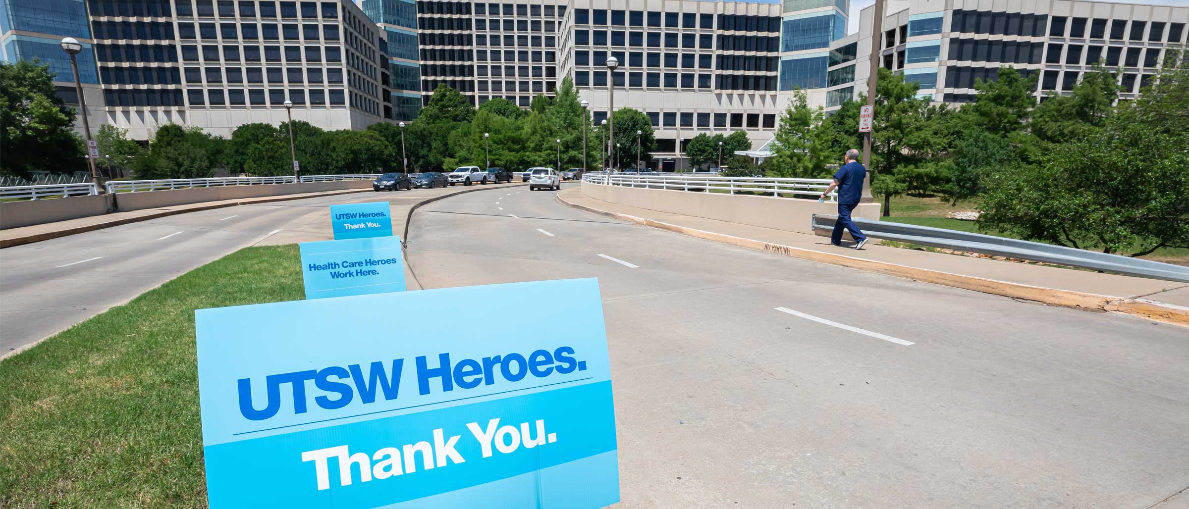 Sign that reads UTSW Heroes, thank you in front of a large building