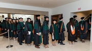 Students stand in line, eagerly waiting to enter the symphony hall and earn their degrees.