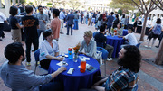 Hundreds of attendees enjoy the outdoor reception for the Brown and Goldstein partnership celebration.