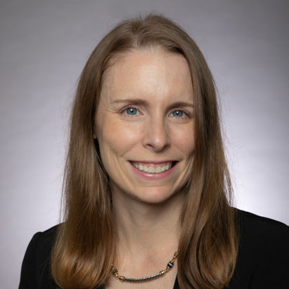 Woman with dark blond hair and black blazer