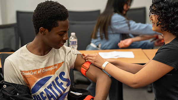 Students practice using a tourniquet.
