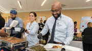 Nutrition Services contractor Drayon Amerson serves up collard greens.