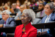 Dr. Hannah Valantine looks on as she is introduced as the keynote speaker.