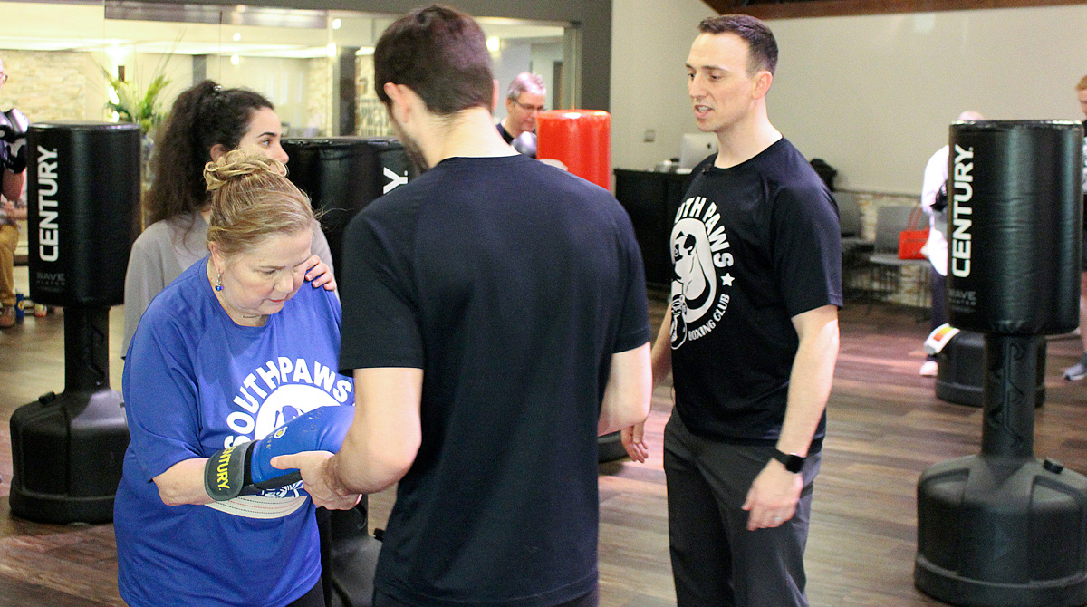 Partipant leaning on therapist during exercise