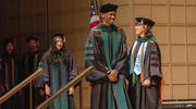 Chijindu Iheanacho, M.D., (center) receives final words of encouragement from Angela Mihalic, M.D., Dean of Medical Students and Associate Dean for Student Affairs.