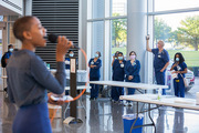 Executive Recruiter Brittanny Anderson serenades health care workers at Clements University Hospital to provide comfort amid the ongoing COVID-19 pandemic.