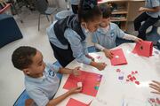 Students work together to make some creative Valentine’s Day cards.