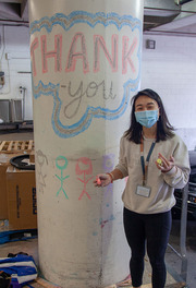 Connie Ma, Medical School Class of 2021, gives a utilitarian parking garage post a gratitude makeover.