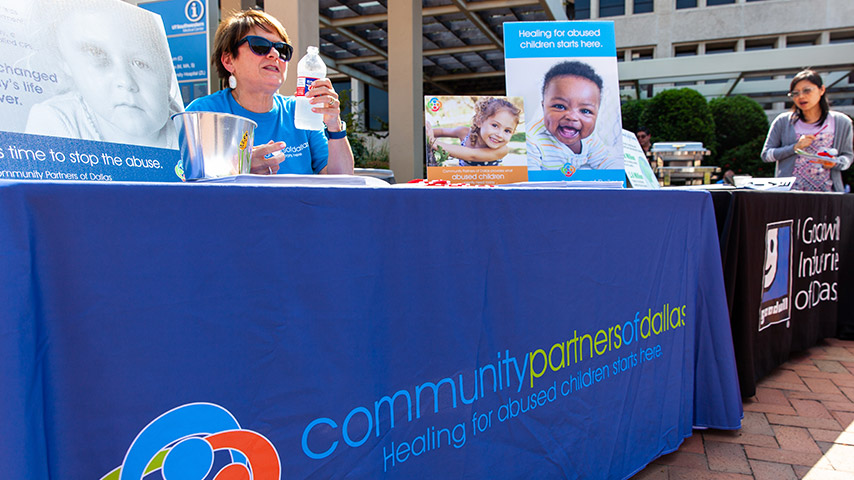 Tables lined up with material for various charities