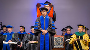 Yang Liu, Ph.D., is hooded by Xiaochun Li, Ph.D., Associate Professor of Molecular Genetics and Biophysics, at the May 18 Graduate School of Biomedical Sciences commencement ceremony. Dr. Li is a Rita C. and William P. Clements, Jr. Scholar in Biomedical Research.