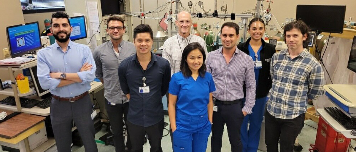 Group of people in a room surrounded by medical equipment