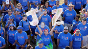 A group member proudly holds her JZ letters high for her team.